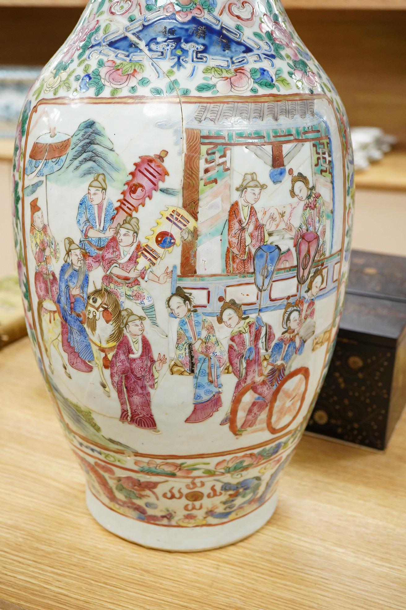 A large Chinese famille rose vase enamelled with figures and flowers, 59cm high (damaged and repaired)
